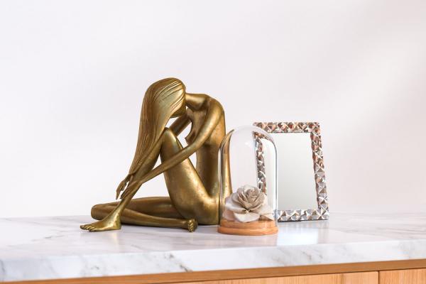 Bronze woman sculpture, mirror and rose