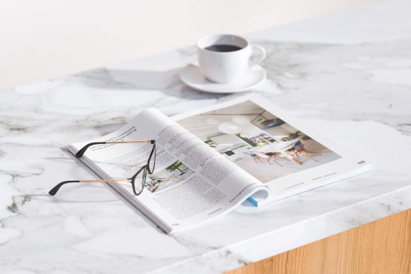 open magazine, glasses and  cup of coffe